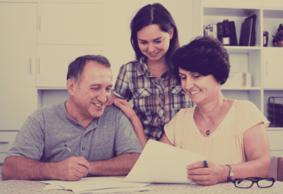 Two parents co-signing a lease for their daughter.