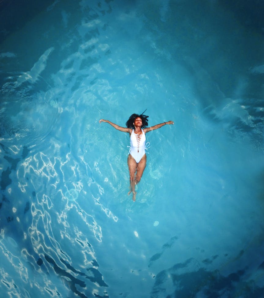 a blissful renter floats in their rental property pool