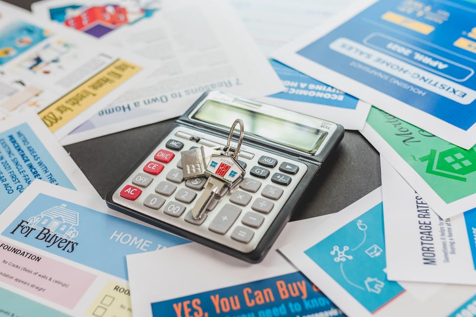 A calculator and real estate flyers depicting financial planning behind build to rent for property owners.