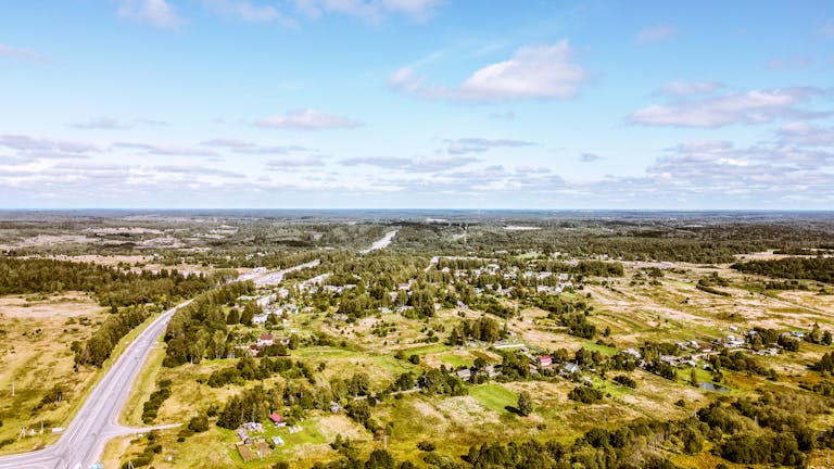 Breathtaking aerial view of a vast, rural countryside with fields, forests, and winding roads symbolizing the hottest economic destination, Johnston County.