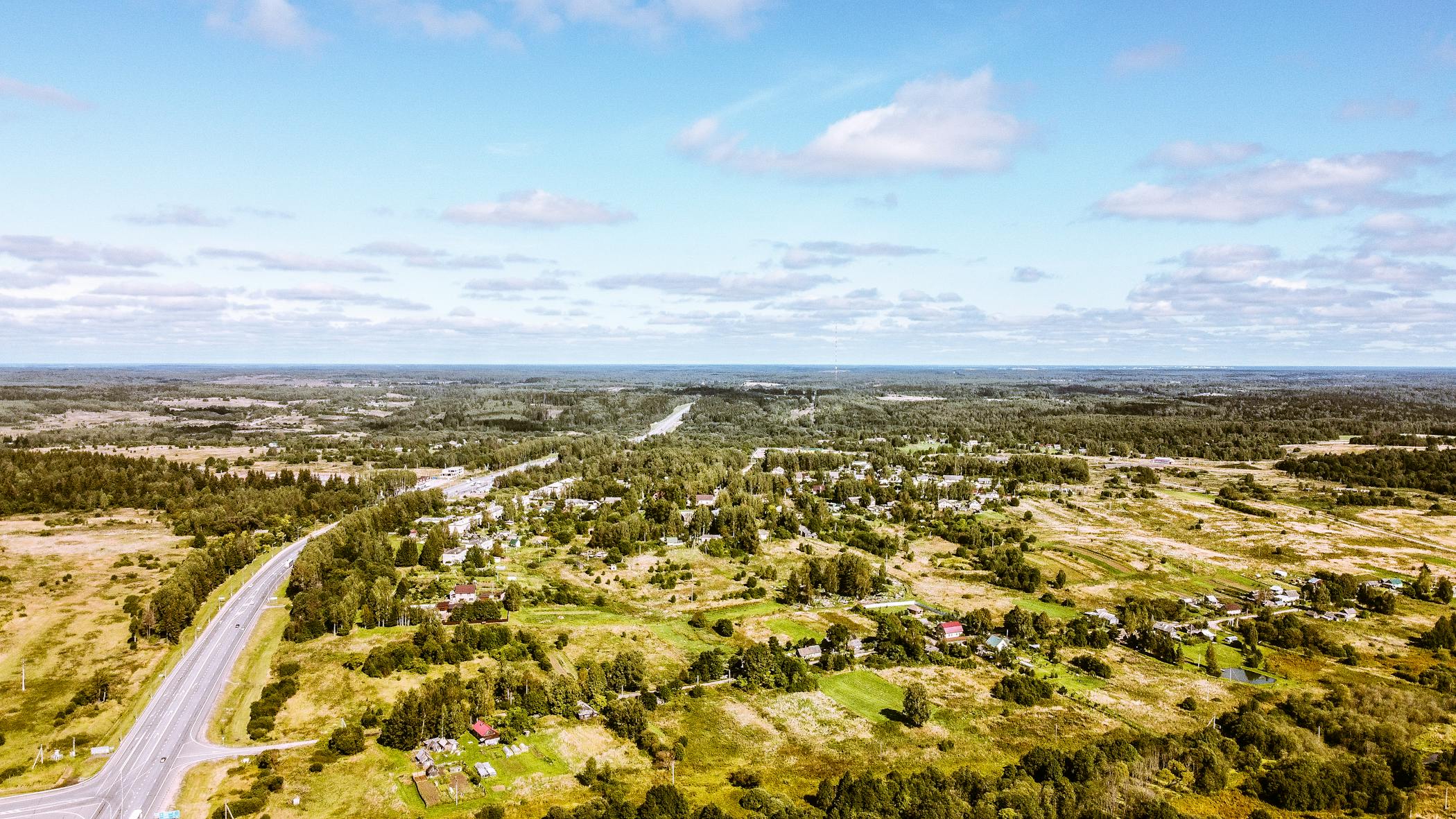 Breathtaking aerial view of a vast, rural countryside with fields, forests, and winding roads symbolizing the hottest economic destination, Johnston County.