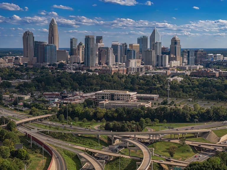 A vibrant view of Charlotte's modern skyline and highways showcasing the #5 top best places to live in America.
