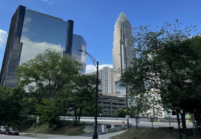 Stunning view of Charlotte's skyline featuring modern skyscrapers under a clear blue sky.