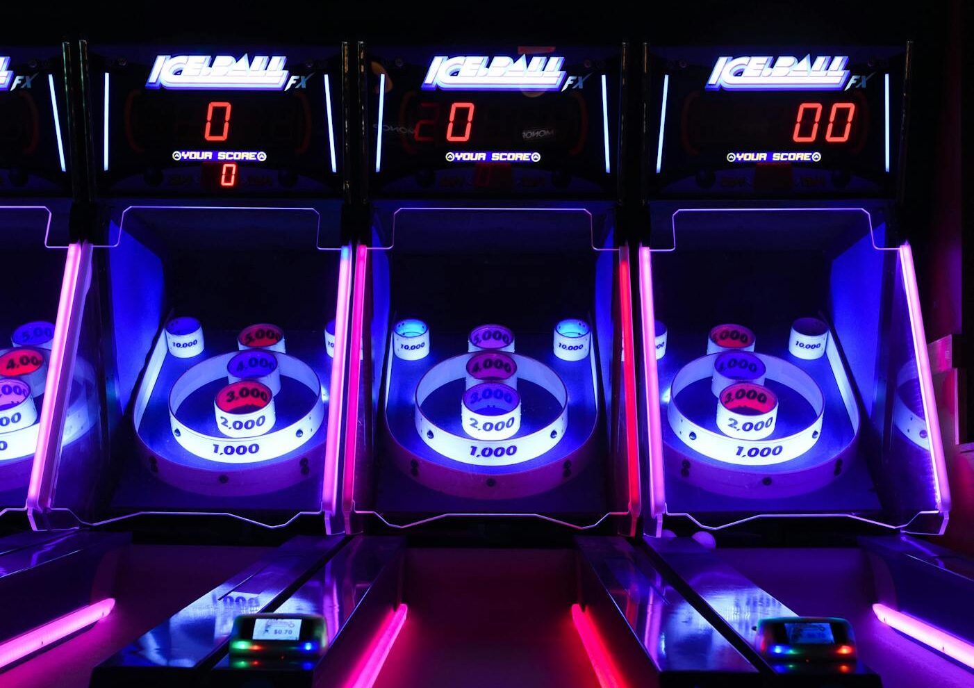 Vibrant and illuminated ski ball machines in a dark arcade setting showcasing the new Dave and Buster's coming to Wilmington, NC.
