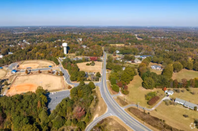 A scenic aerial view of Fort Mill showcasing verdant landscapes, residential areas, and its charming suburban layout.