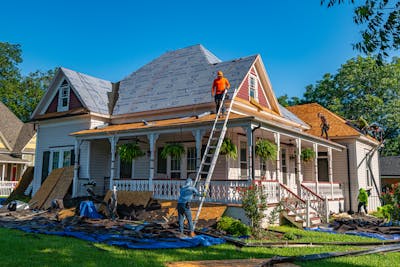 Roofers replace the roof of a home in Texas showcasing America's housing construction powerhouse.