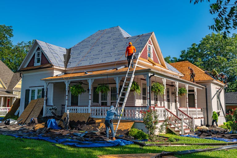 Roofers replace the roof of a home in Texas showcasing America's housing construction powerhouse.