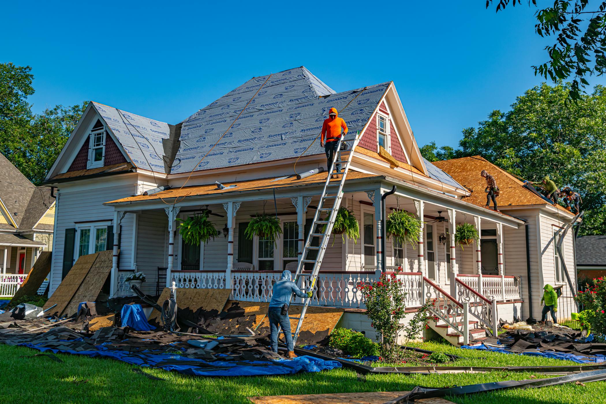 Roofers replace the roof of a home in Texas showcasing America's housing construction powerhouse.