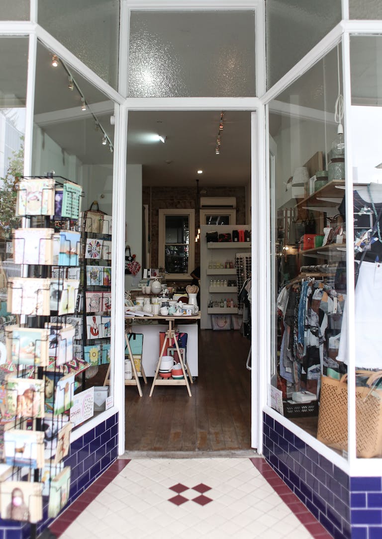 Elegant boutique entrance showcasing diverse merchandise for a unique shopping experience in a small SC Downtown