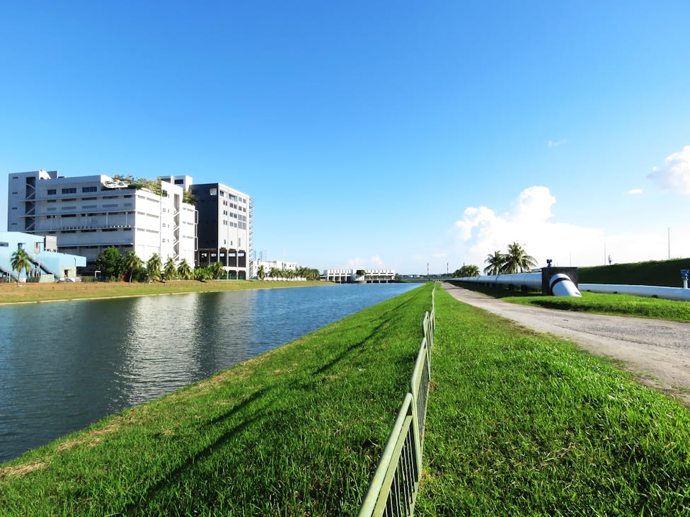 Modern industrial building Housing the Fujifilm expansion in Holly Springs NC by a canal with clear blue sky