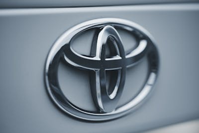 Detailed image of a shiny silver Toyota emblem on a vehicle's surface showcasing a new Toyota battery plant coming to North Carolina.