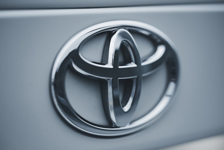 Detailed image of a shiny silver Toyota emblem on a vehicle's surface showcasing a new Toyota battery plant coming to North Carolina.
