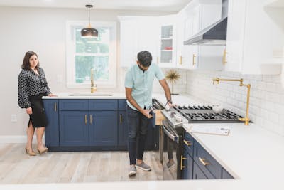 Real estate agent showcasing a potential new home buyer inspecting a modern kitchen interior for a potential purchase.