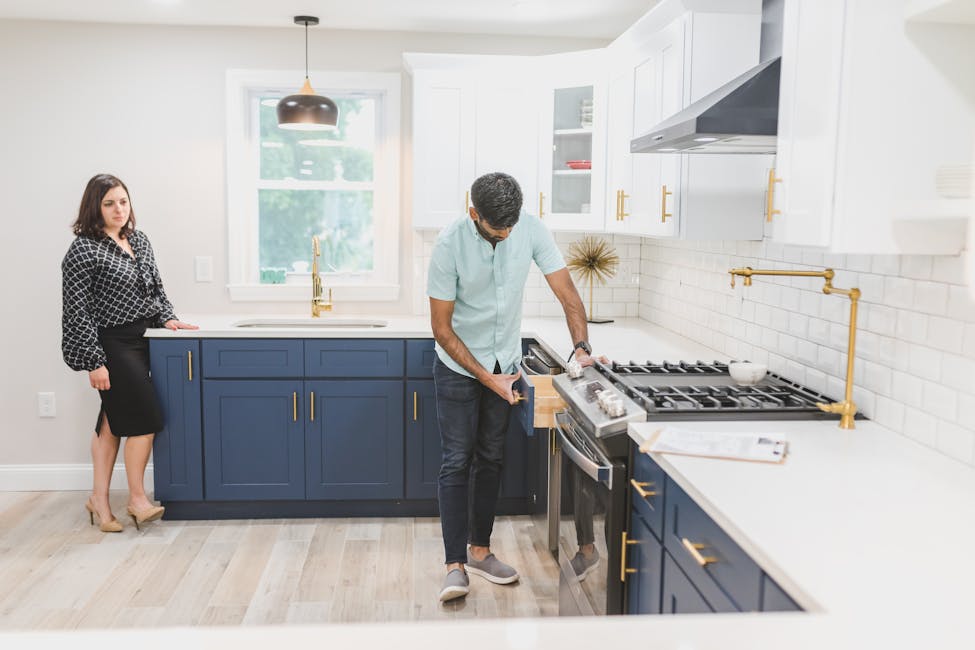 Real estate agent showcasing a potential new home buyer inspecting a modern kitchen interior for a potential purchase.