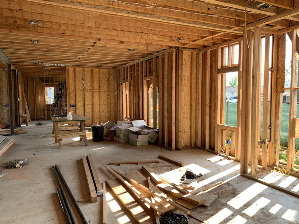 Sunlit interior with wood framing, showcasing build to rent construction progress and current market trends for investors.
