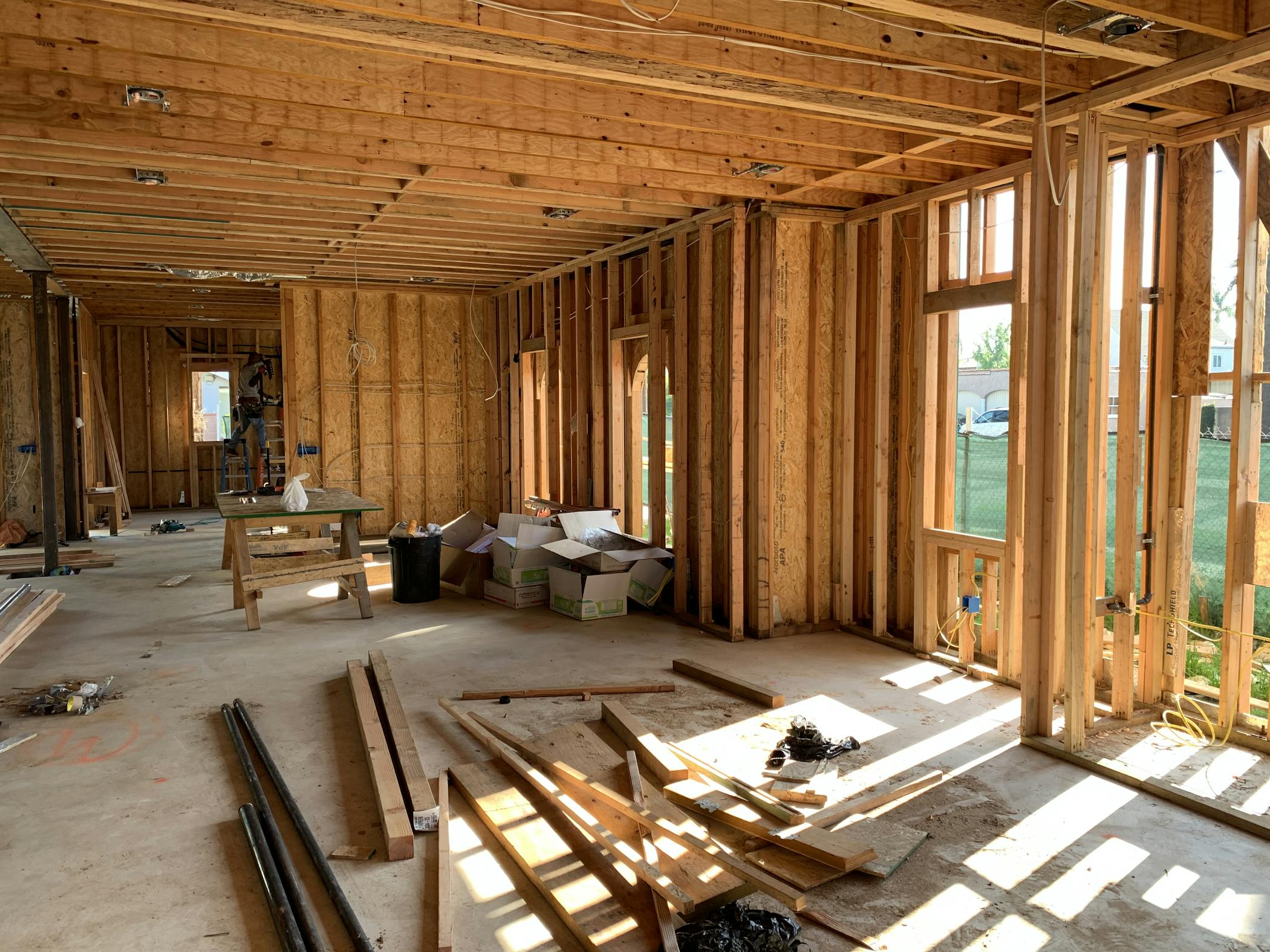 Sunlit interior with wood framing, showcasing build to rent construction progress and current market trends for investors.