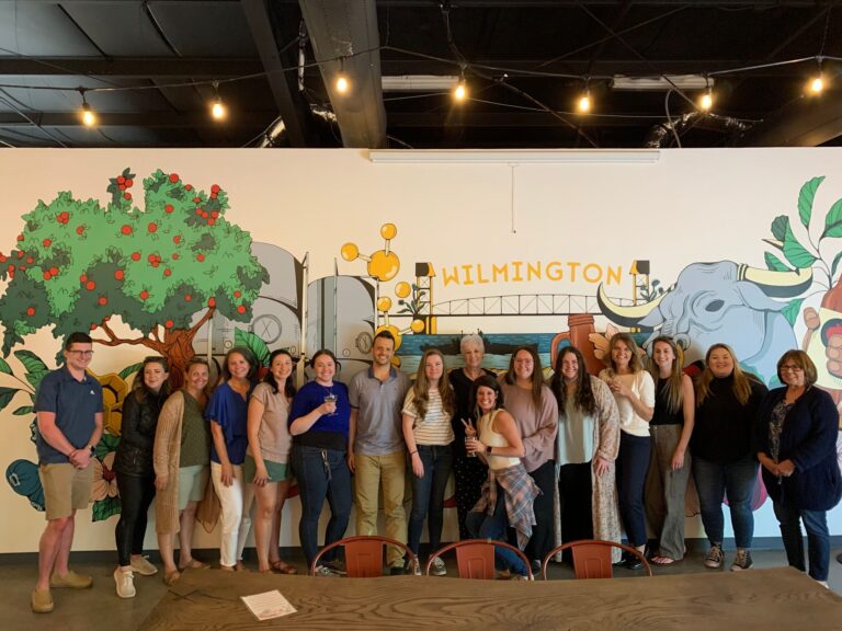 MoveZen Property Management team group photo in front of a Wilmington mural