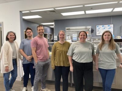 MoveZen Property Management team volunteering in the kitchen at the New Hanover County Senior Center in Wilmington, NC
