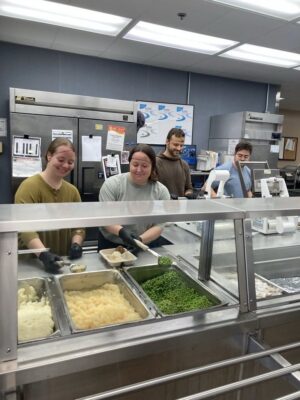 MoveZen Property Management team volunteering in the kitchen at the New Hanover County Senior Center in Wilmington, NC