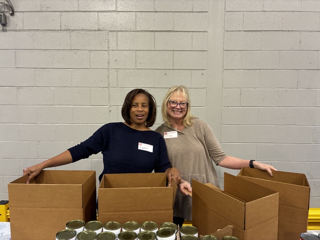 MoveZen volunteers Lynn Setzer and Lisa Scott with food boxes at Second Harvest Food Bank in Charlotte NC