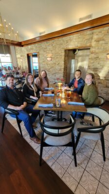 MoveZen Property Management Wilmington team seated at their 2024 holiday lunch